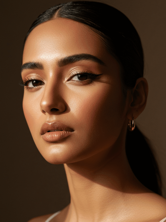 “Close-up of a South Asian woman with demi-matte skin, glowing cheeks, subtle highlight on nose, natural glam makeup, soft golden-hour lighting, 2025 beauty trend”